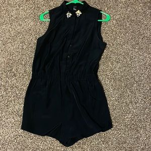Black shorts romper w/ embellished collar. Elastic waist. Size small.